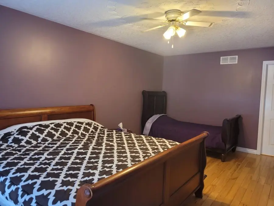 Master bedroom with king bed and hardwood floors